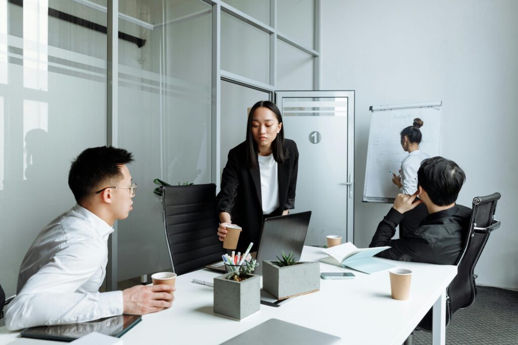 Diverse office team engaged in a collaborative meeting discussing business strategies.